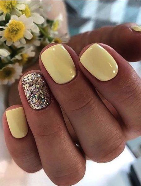 Pastel yellow summer nail colors on light skin